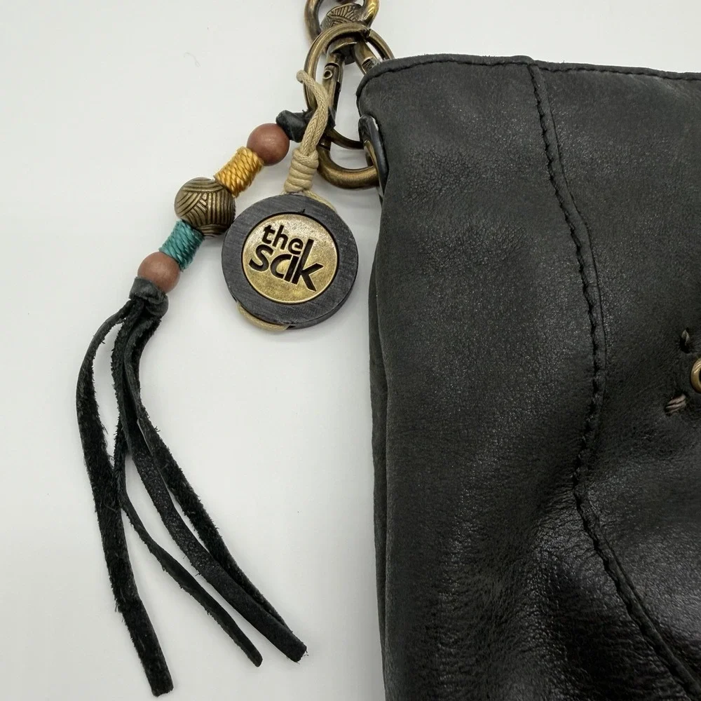 The Sak Indio Demi Leather Hobo Bag Braided Strap Whipstitch Charm Logo Black